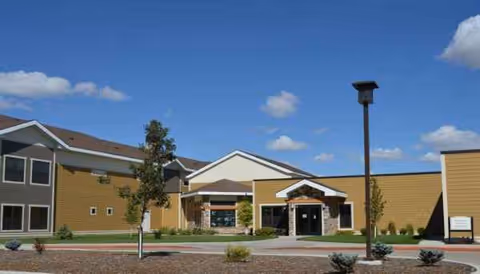 Exterior view of St Luke's Home with front entrance and landscaping.