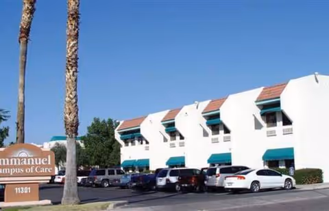 Exterior view of Immanuel Campus of Care building with parked cars.