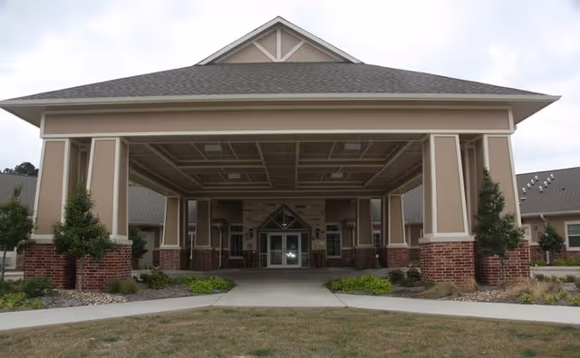 Front view of Autumn Wind Assisted Living entrance with a covered porte-cochère.