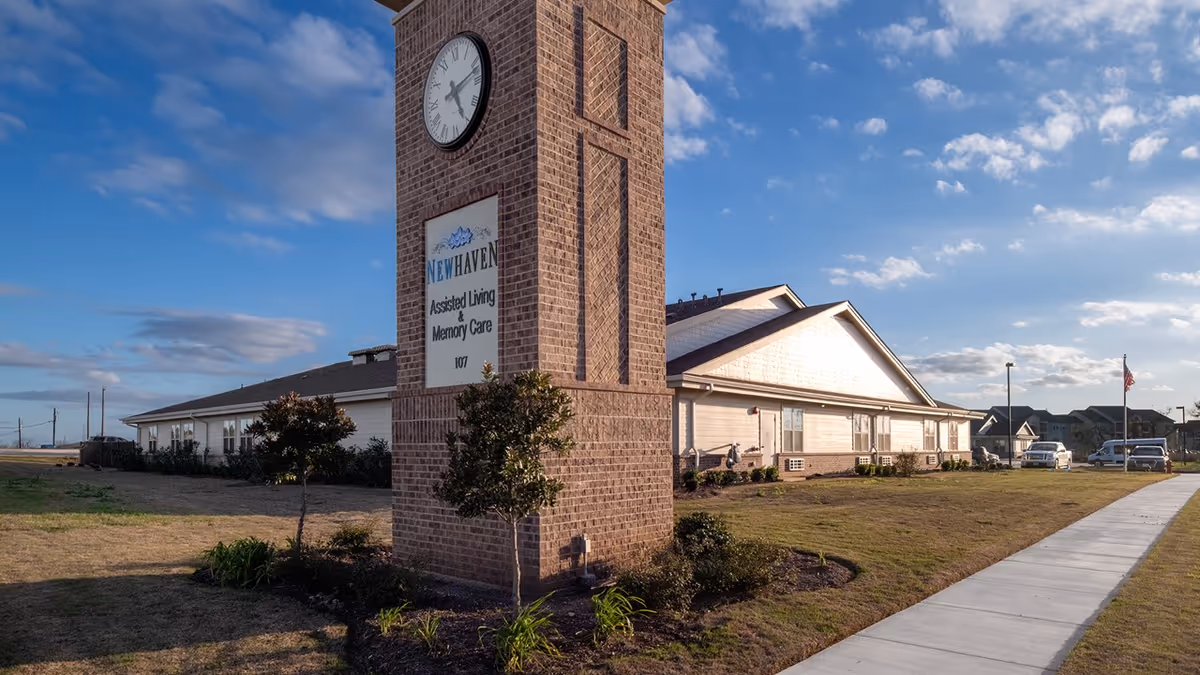 Brick clock tower sign marks the front of New Haven Assisted Living facility in Floresville.