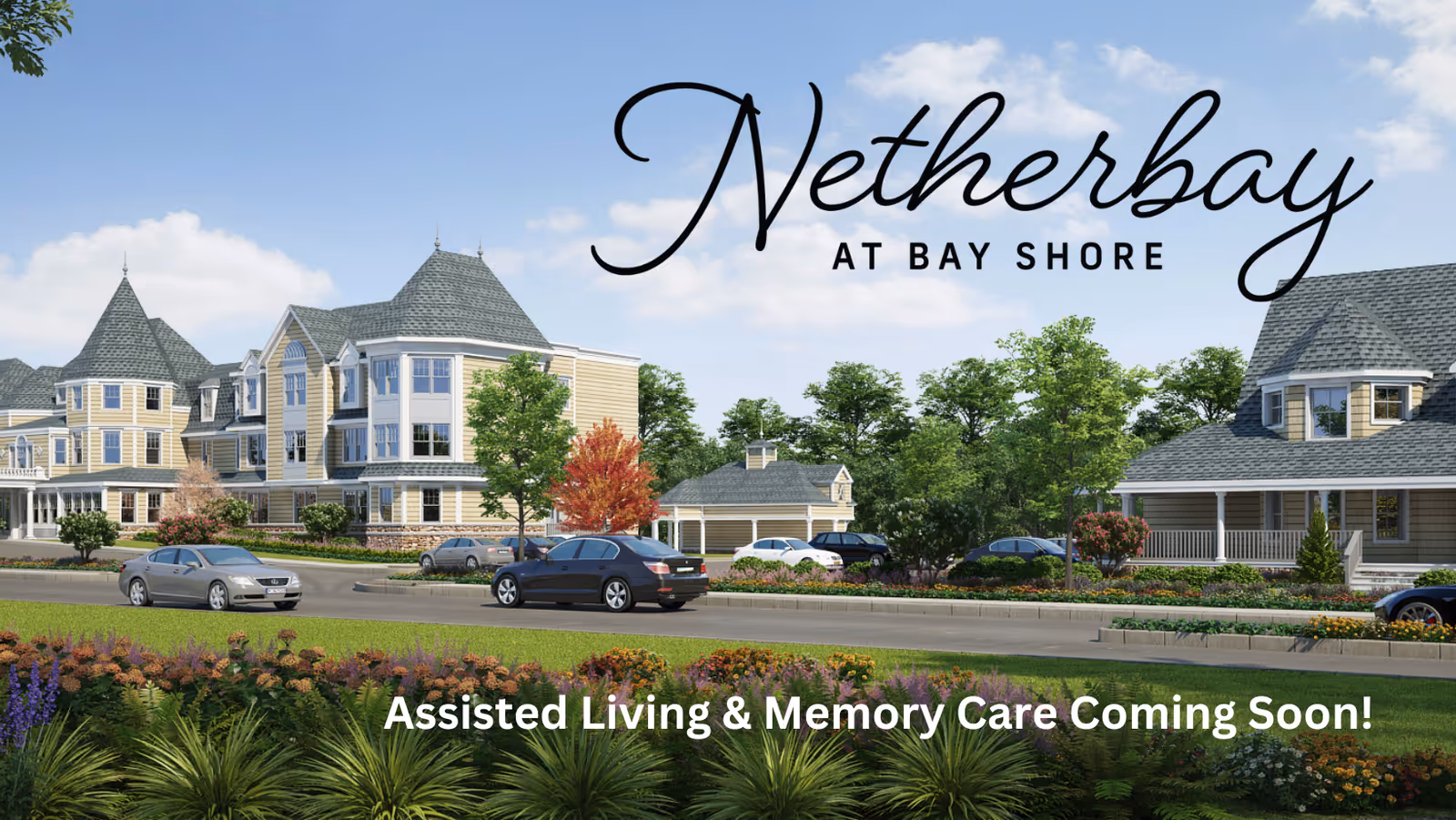 Exterior view of a large, elegant assisted living facility with multiple buildings featuring gray roofs and beige siding, surrounded by trees, shrubs, and a well-maintained garden. Several cars are parked along the road in front of the buildings under a clear blue sky.