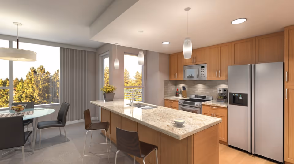 Modern kitchen with wooden cabinets, a large marble countertop island with a sink, three pendant lights hanging above, and stainless steel appliances including a refrigerator, microwave, and stove. To the left, there is a dining area with a round glass table and four chairs, with large windows showing trees outside.