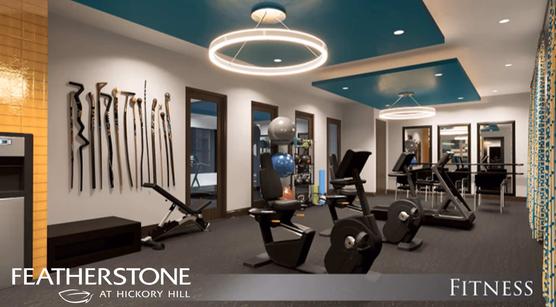 Interior fitness room with exercise bikes, a weight bench, exercise balls and circular ceiling lights.