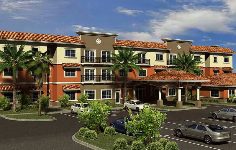 Exterior view of a three-story senior living facility with Mediterranean-style architecture, featuring red-tiled roofs, balconies, palm trees, and a covered entrance with parked cars in front.