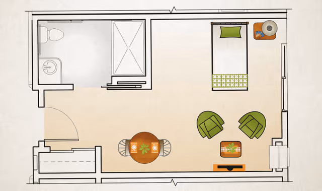Floor plan of a small living space featuring a bathroom with a toilet, sink, and shower on the left side. The main room includes a single bed with a pillow and blanket, a small round dining table with two chairs, two green armchairs with a small coffee table between them, and a TV stand. The entrance door is located at the bottom left corner.