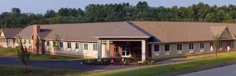 Single-story senior living facility with a covered entrance and landscaped front.