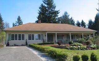 Front view of a single-story River Valley Adult Family Home with manicured lawn.