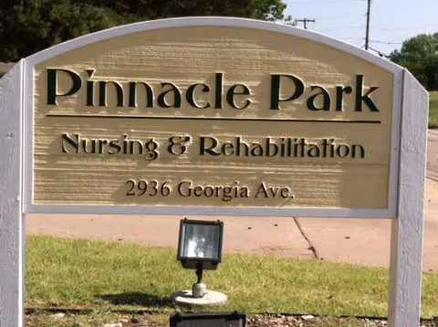Sign reads Pinnacle Park Nursing & Rehabilitation, 2936 Georgia Ave., on a grassy roadside.