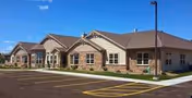Exterior of Majestic Heights Assisted Living with brick facade and accessible entrance.