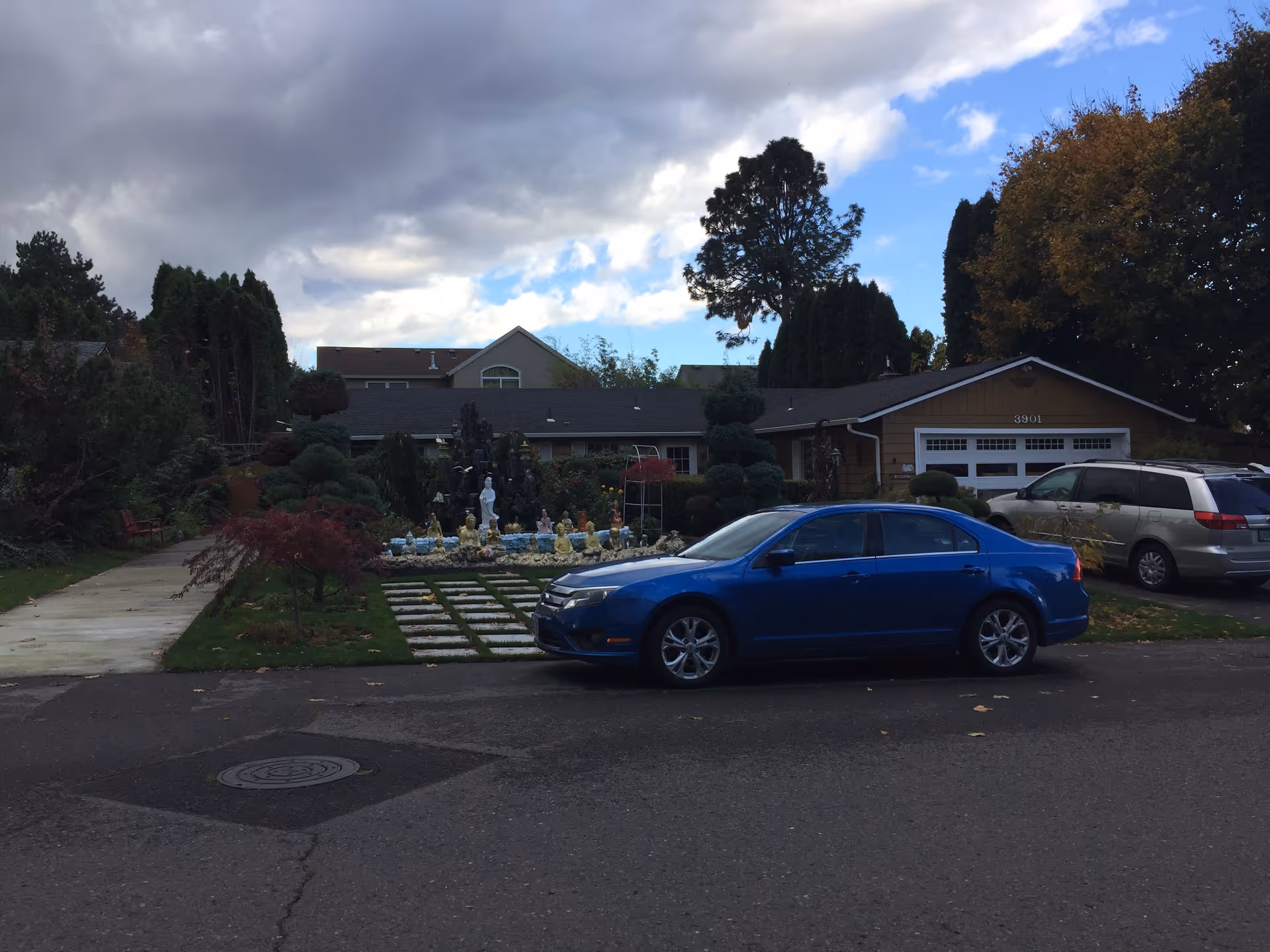 Broyles Home Care exterior with decorative statues and parked cars.