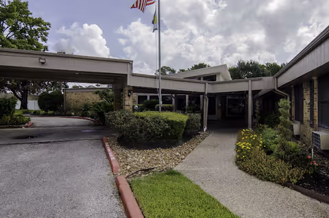 Exterior view of the Lawrence Street Health Care Center entrance with a walkway and landscaping.
