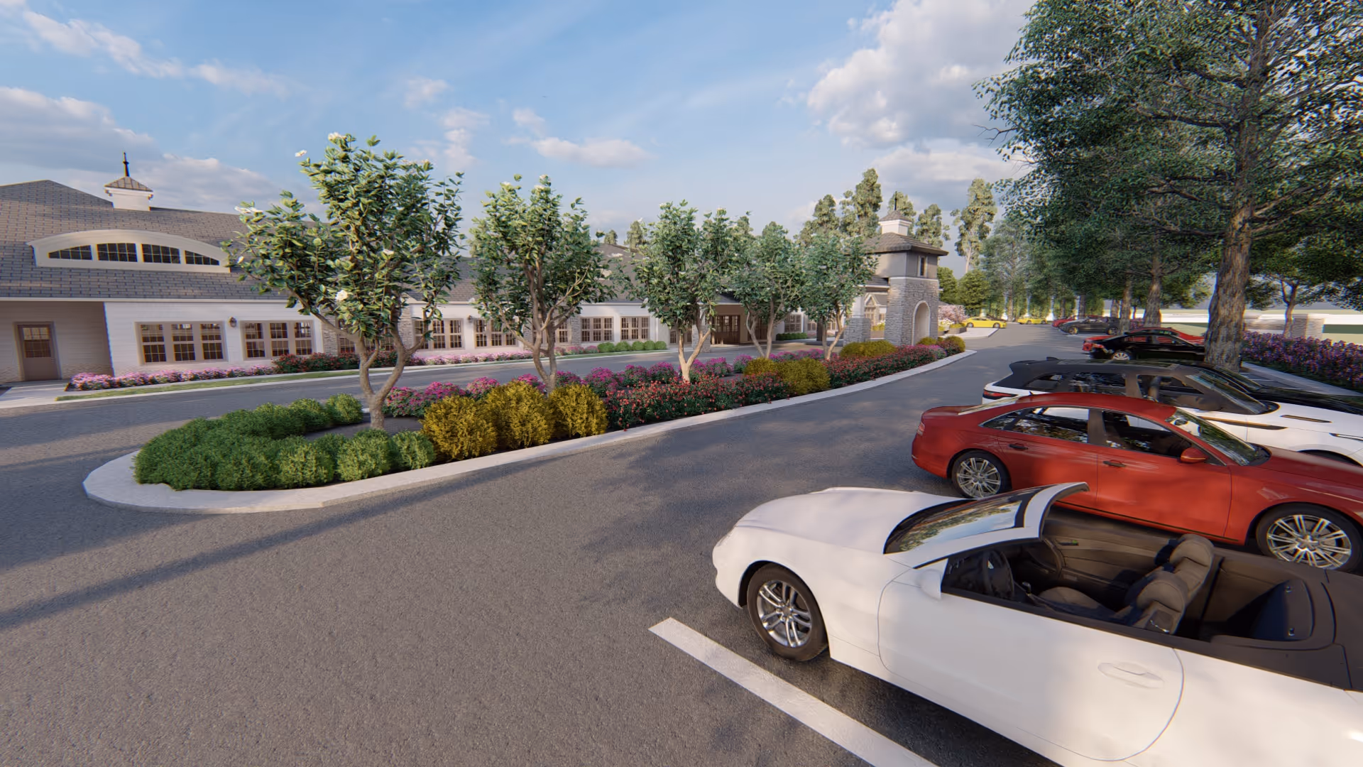 Parking lot with several parked cars including a white convertible in the foreground, landscaped greenery with trees and bushes, and a large building with multiple windows and a cupola in the background under a partly cloudy sky.