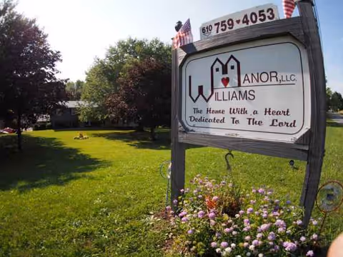 Sign for William's Manor senior living facility on a grassy front yard.