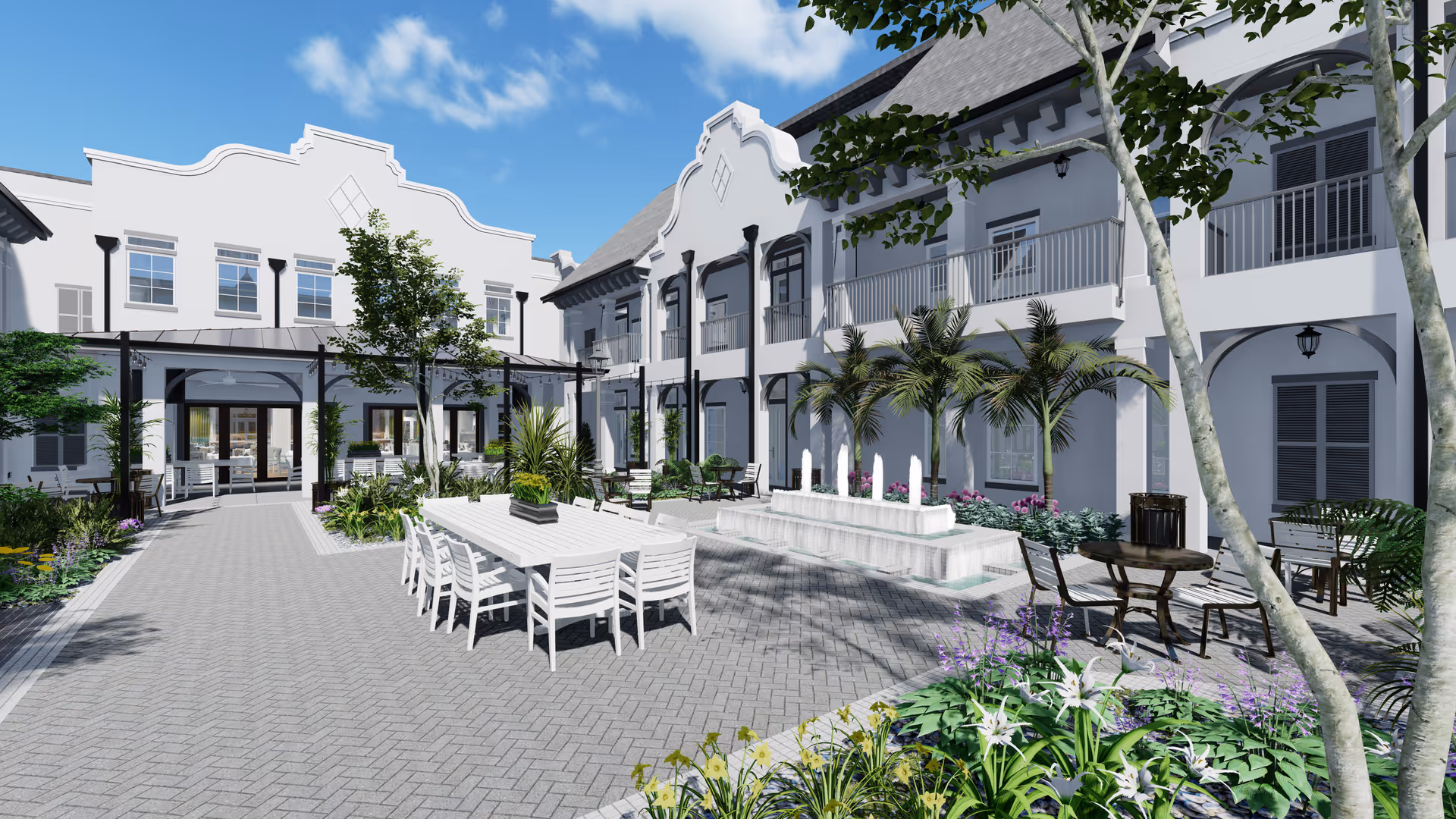 Sunlit courtyard with outdoor dining tables, a central fountain, palm trees, and a two-story white building with balconies.