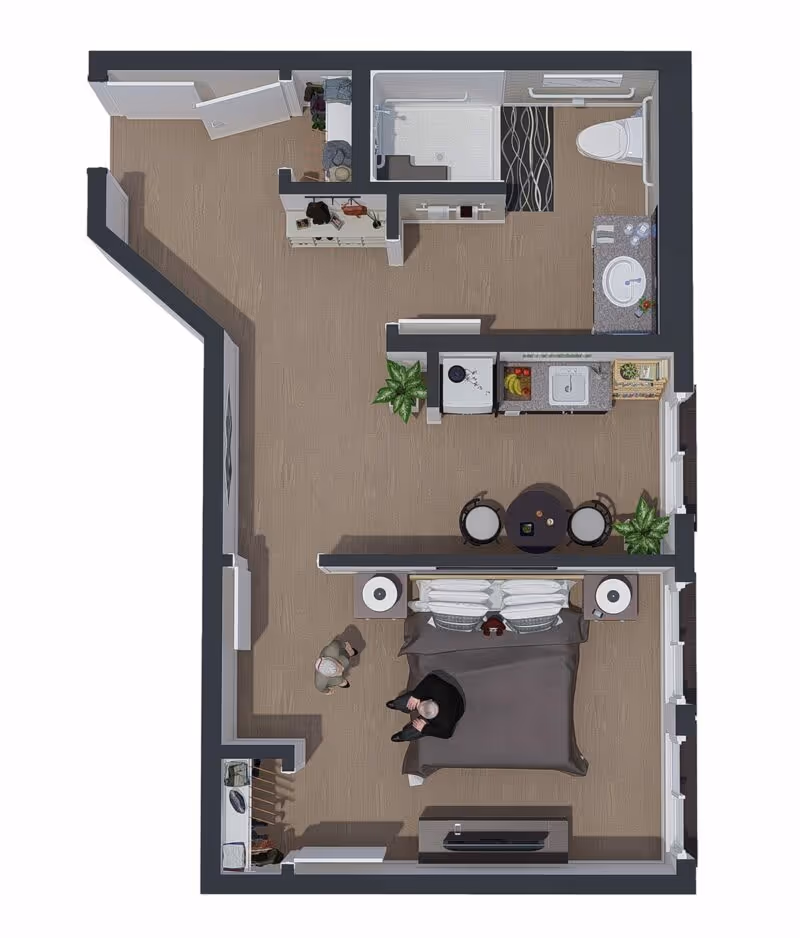 Top-down view of a studio apartment floor plan featuring a bedroom area with a bed, two nightstands, and a TV stand. Adjacent to the bedroom is a small dining area with a round table and two chairs. The kitchen area includes a sink, stove, and counter space. The bathroom has a shower, toilet, and sink with a countertop. There are two people visible in the bedroom area.