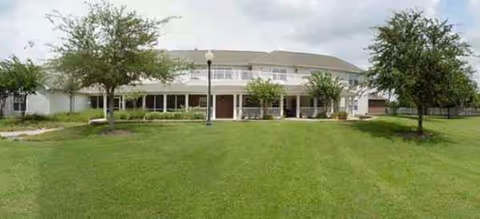 Front view of Brookdale Shadowlake building with green lawn, trees, and a covered entrance.