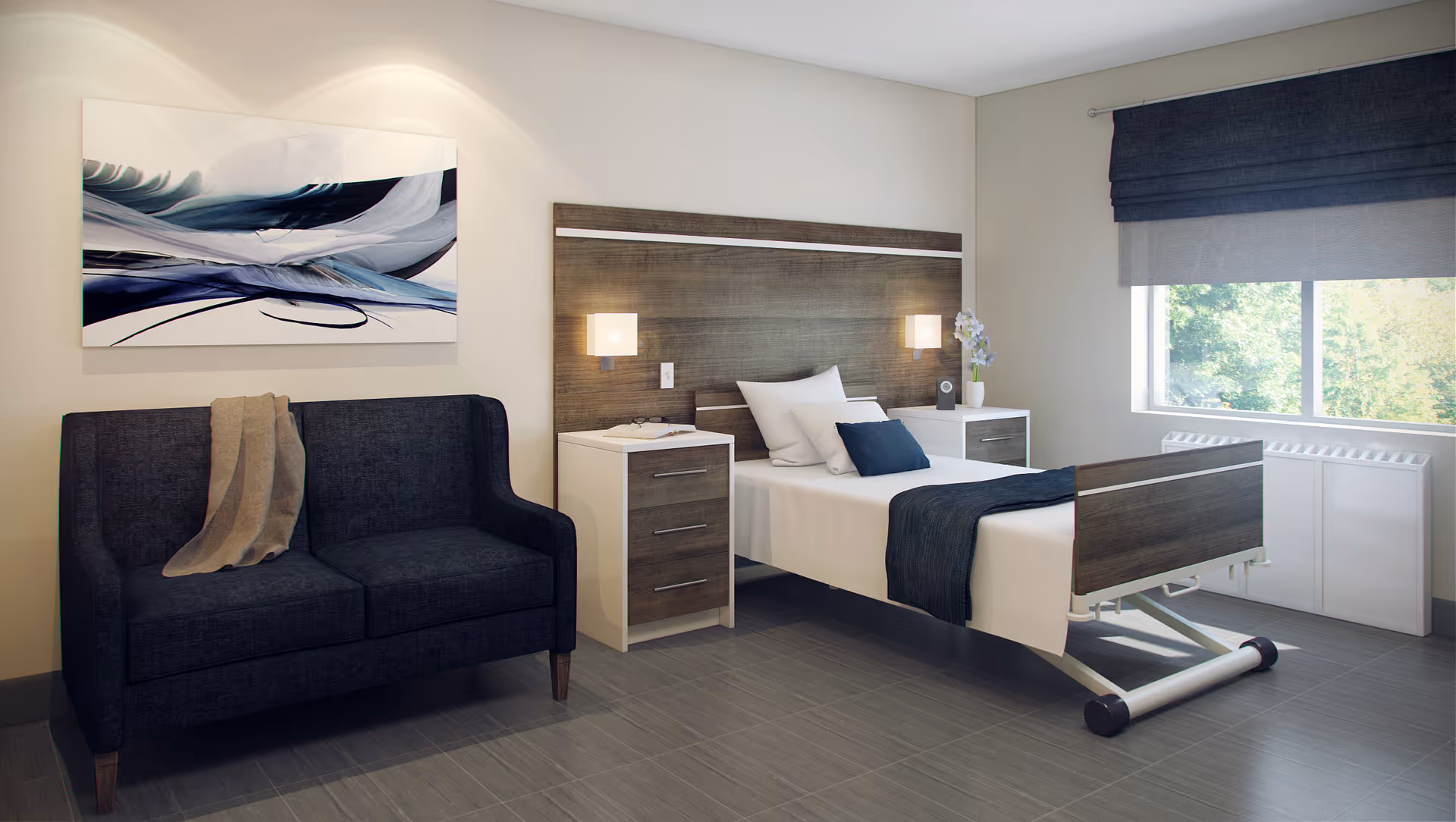 A modern senior living bedroom with a single adjustable bed featuring white and dark blue bedding, two bedside tables with lamps, a dark blue loveseat with a beige throw blanket, abstract artwork on the wall, and a large window with blue curtains letting in natural light.