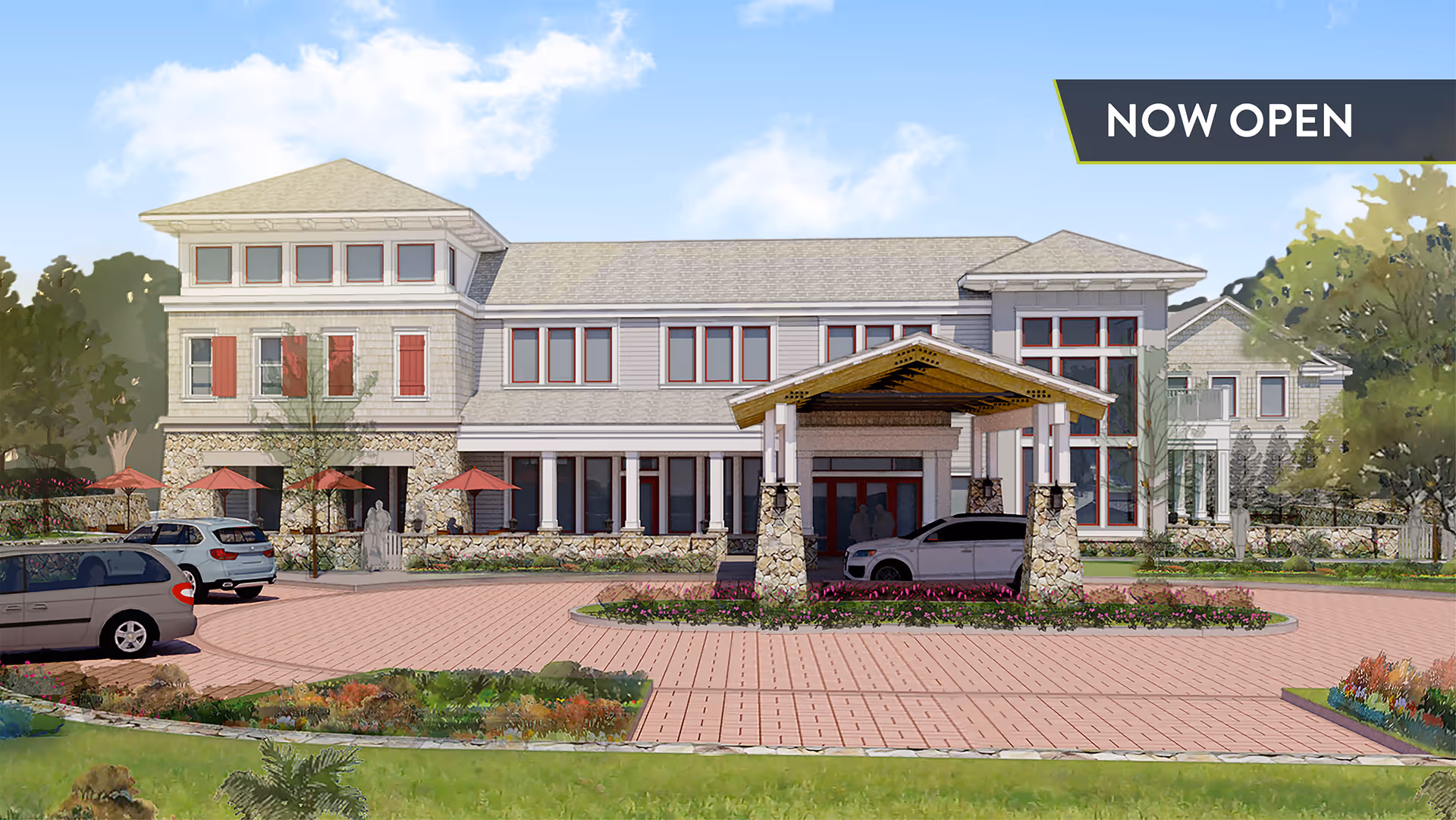 Front exterior view of a senior living building with a covered entrance/porte-cochere, parked cars, landscaping, and a 'NOW OPEN' banner.