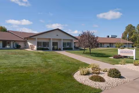 Front view of Cornell Health Services senior living facility with green lawn and walkway.