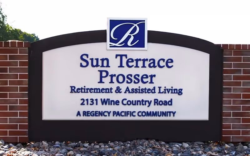 Outdoor sign between brick columns reading "Sun Terrace Prosser Retirement & Assisted Living, 2131 Wine Country Road".