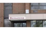 Exterior view of a brick building with large windows and a white awning displaying the name 'Bernardine'.