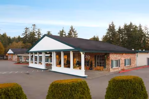 Exterior view of Life Care Center of Coos Bay with covered entrance and brick facade.