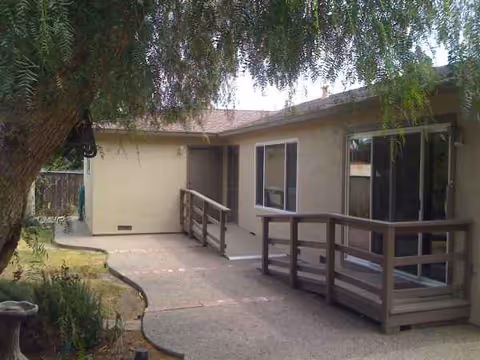 Exterior view of Villa Vietri Board and Care with a ramped walkway and sliding doors.