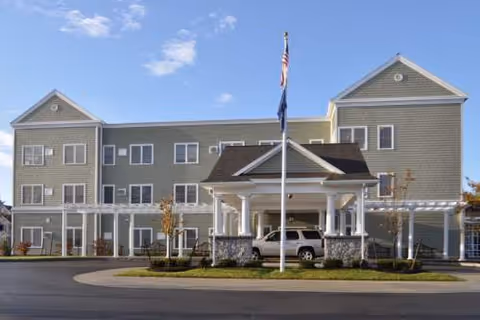 Exterior view of Inn at Atlantic Heights, a multi-story senior living facility with a porte-cochère.
