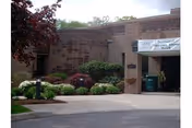 Exterior of Vernon Rehabilitation and Healthcare Center with entrance and landscaped brick facade.