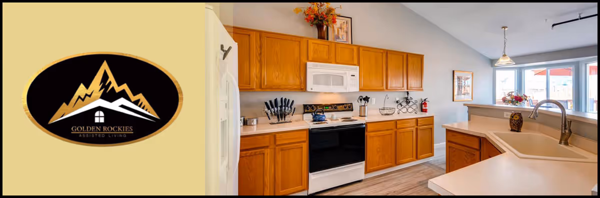 Open-concept kitchen with oak cabinets, white appliances, a peninsula sink, and a Golden Rockies Assisted Living logo panel at left.