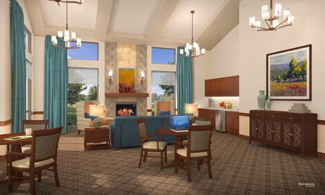 A spacious and well-lit living room area with high vaulted ceilings, large windows with teal curtains, a stone fireplace with a colorful painting above it, several wooden tables and chairs, a blue sofa, and a wooden sideboard with decorative vases and a framed landscape painting. The room has carpeted flooring and modern light fixtures hanging from the ceiling.