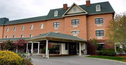 Holiday Manor at Woodside exterior with brick facade and a covered entrance.