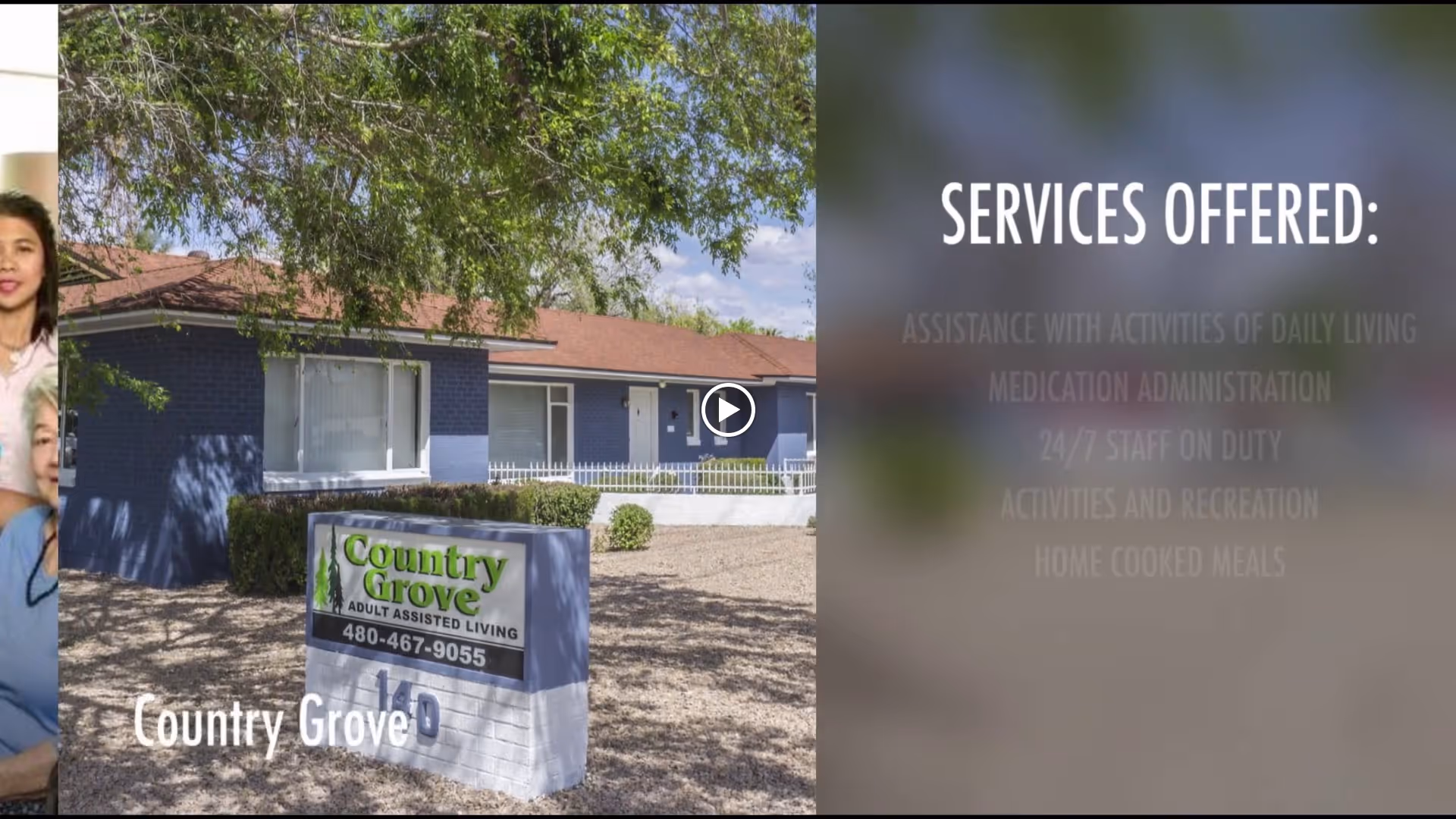 Exterior view of a single-story assisted living facility building with a sign in front that reads 'Country Grove Adult Assisted Living' along with a phone number. The building has a blue exterior with white trim and a brown roof, surrounded by gravel and some bushes under a tree.