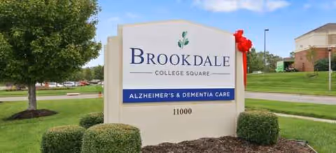 Brookdale College Square exterior sign with landscaped shrubs and Alzheimer’s & Dementia Care notice.