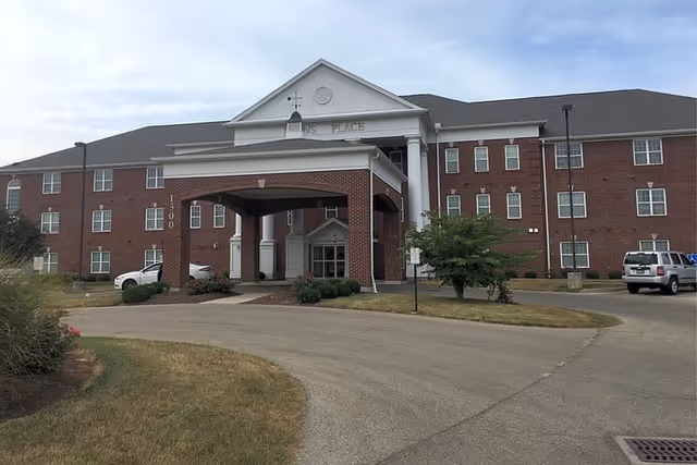 Exterior view of Lyons Place I senior living facility with a brick building and covered entrance.