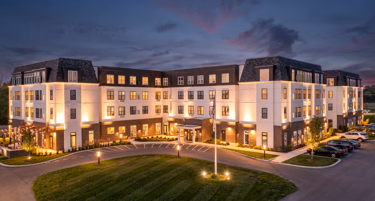 Exterior view of Vita of Marion senior living facility illuminated at dusk.