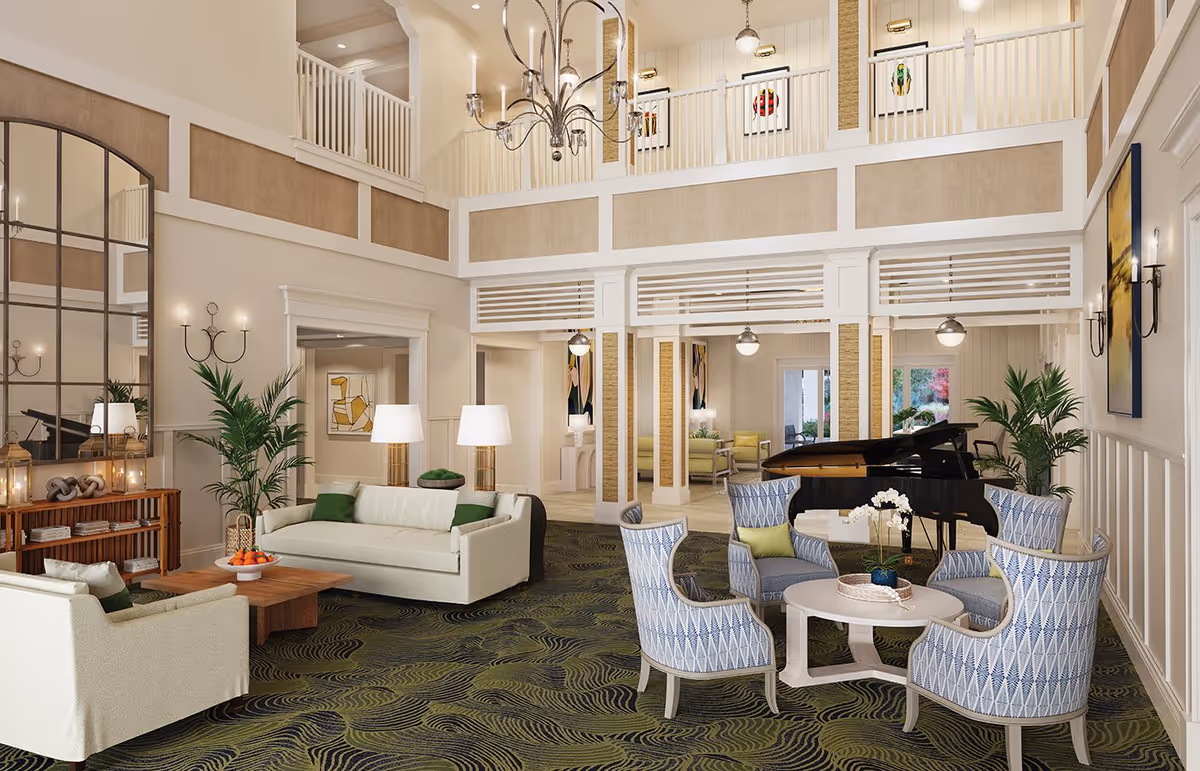 Two-story communal lounge with sofas and armchairs arranged around tables, a grand piano, chandelier lighting, and indoor plants.