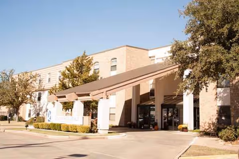 Exterior view of University Place Independent Living showing the entrance canopy and landscaped frontage.