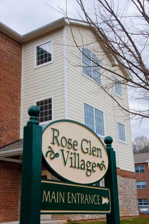 Exterior view of Rose Glen Villages building with a large Main Entrance sign.