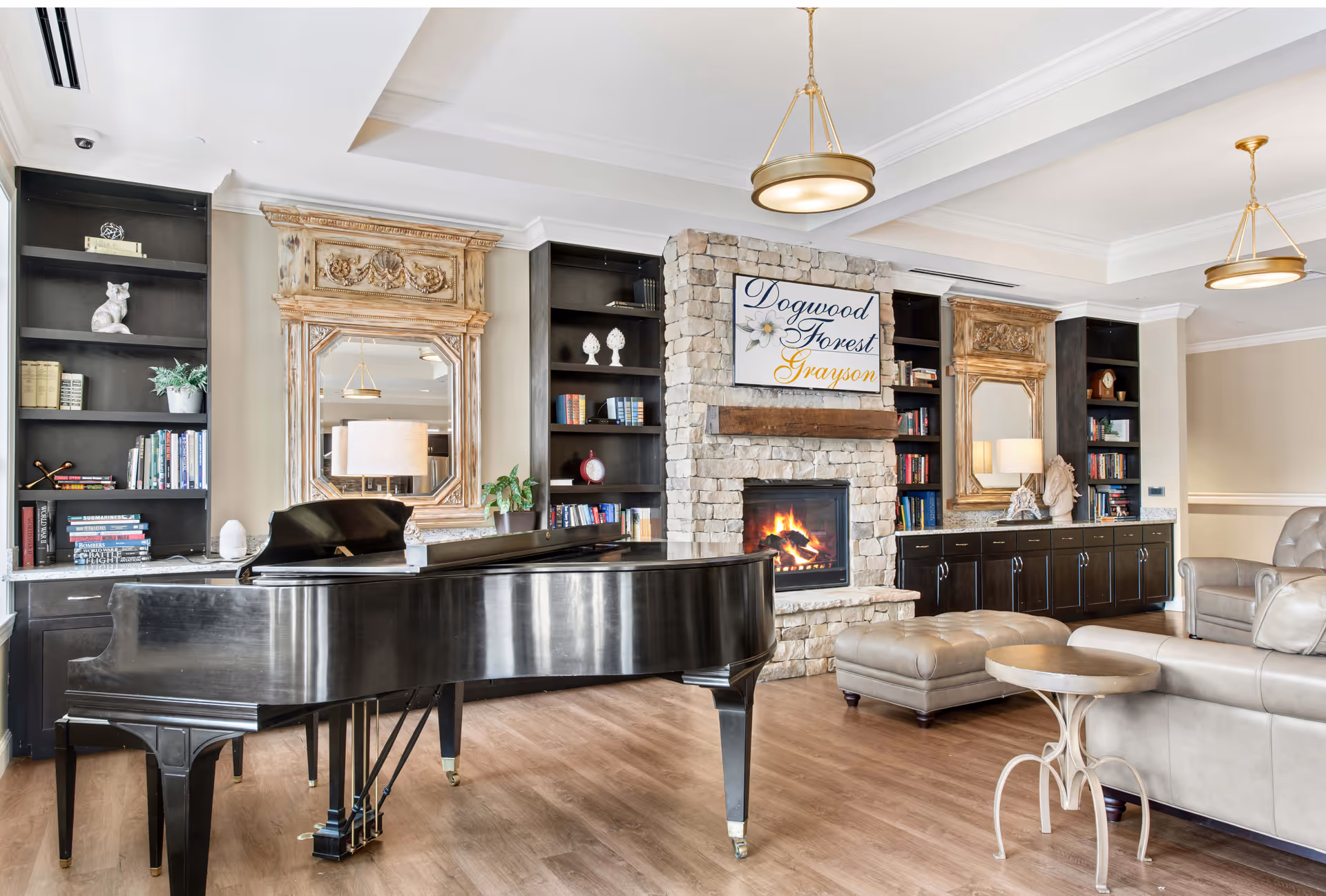 Luxurious senior living lounge with a grand piano, stone fireplace, and built-in bookshelves.