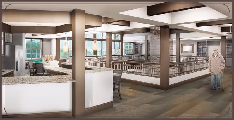 Interior view of a senior living facility common area with a kitchen counter on the left, two elderly women sitting and talking near the kitchen, and an elderly man walking with a cane on the right. The space features large windows, wooden beams, and a railing overlooking a lower level.
