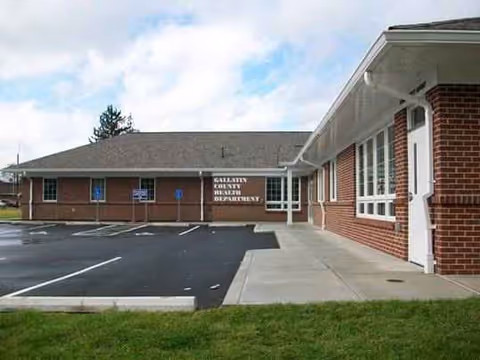 Brick senior care facility exterior with a parking lot and entrance.