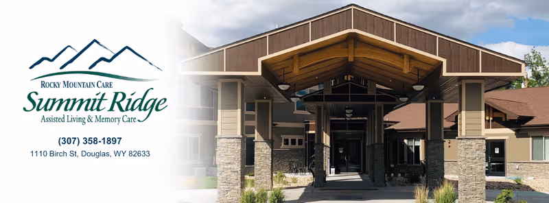 Covered entrance and porte-cochere of a single-story assisted living facility with stone columns and signage.