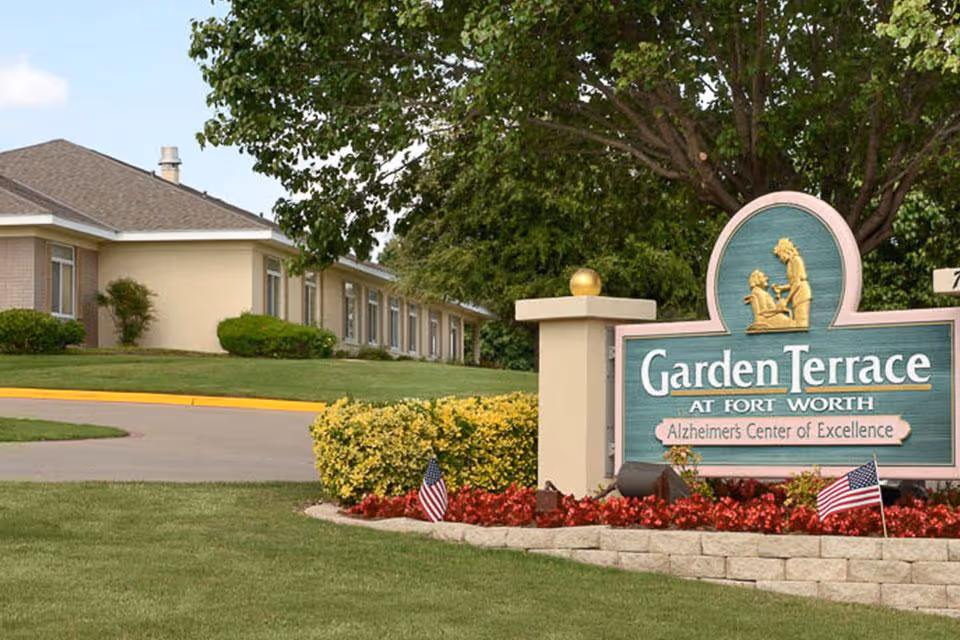 Entrance sign for Garden Terrace at Fort Worth in front of a single-story building and landscaped lawn.