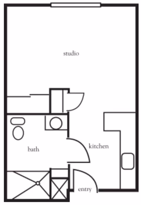 Floor plan of a studio apartment showing an entry area, kitchen, bathroom with toilet and sink, and a main studio living space.