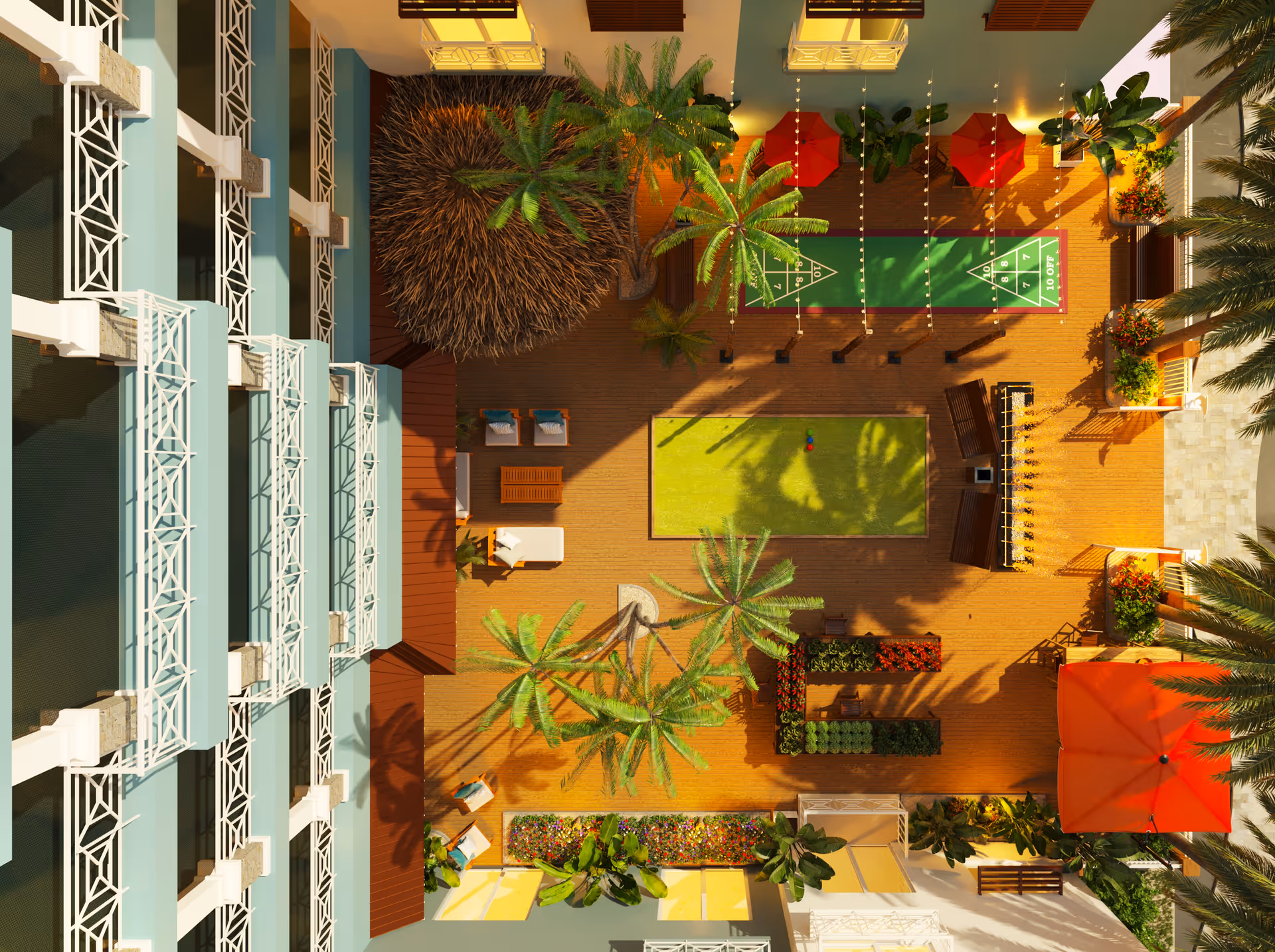 Aerial view of a sunny courtyard with palm trees, seating areas, shuffleboard courts and a central lawn next to a multi-story building.