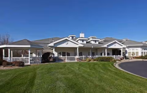 Front view of Bailey Pointe at Roxbury Park, a senior living campus with a manicured lawn.
