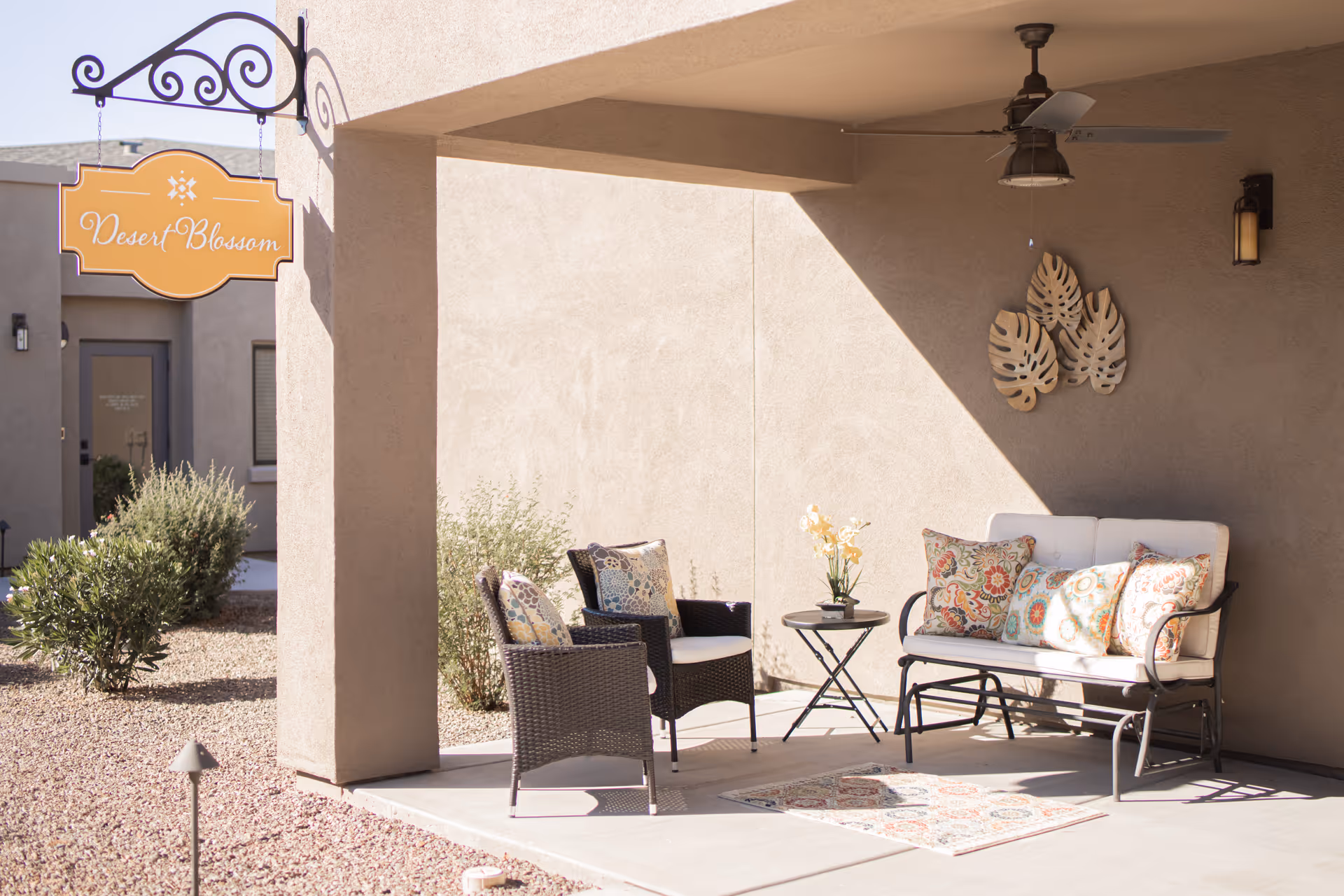 Shaded outdoor patio at Hacienda Del Rey with cushioned seating and decorative pillows.