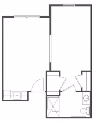 Black and white architectural floor plan showing a layout with a bedroom, bathroom including a shower, toilet, and sink, and an adjoining room with a sink area.