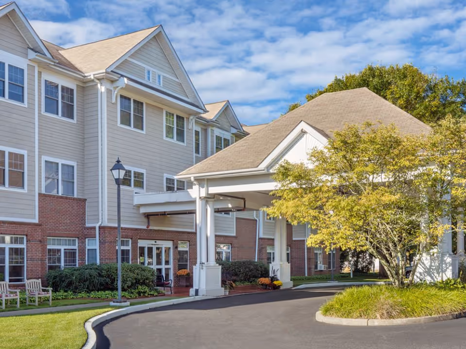 Atria Bay Spring Village exterior with a covered entrance and landscaped grounds.